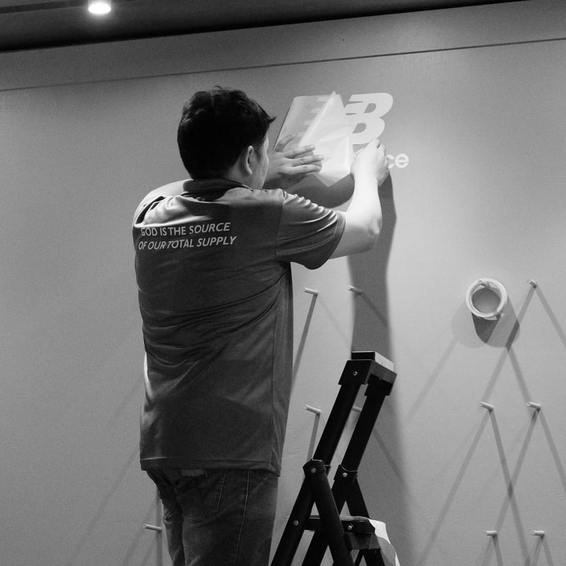 Omnisource team installing a Mission Force wall display